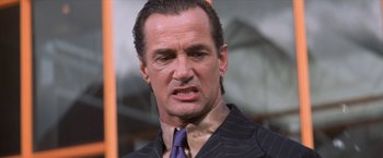 Movie still from “Mr. Nice Guy” (1997), directed by Sammo Kam-Bo Hung – A person wearing a suit and tie; Close Up shot, Low angle