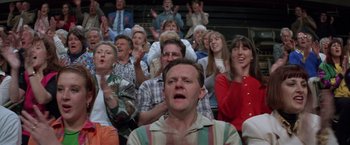 Movie still from “Mr. Nice Guy” (1997), directed by Sammo Kam-Bo Hung – A group of people in a stadium watching a game; Medium shot, High angle