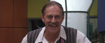 Movie still from “Mr. Nice Guy” (1997), directed by Sammo Kam-Bo Hung – An older man smiling for the camera; Close Up shot, Low angle
