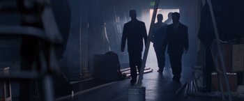 Movie still from “Mr. Nice Guy” (1997), directed by Sammo Kam-Bo Hung – A group of people walking down a dark hallway; Wide shot, Low angle