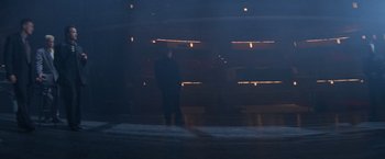 Movie still from “Mr. Nice Guy” (1997), directed by Sammo Kam-Bo Hung – A man standing in a dark room looking at the lights; Extreme Wide shot, Low angle