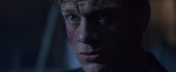 Movie still from “Mr. Nice Guy” (1997), directed by Sammo Kam-Bo Hung – A man's face in the dark; Close Up shot, Low angle