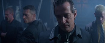 Movie still from “Mr. Nice Guy” (1997), directed by Sammo Kam-Bo Hung – A person wearing a suit and tie; Close Up shot, Low angle