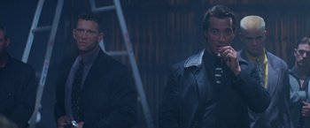 Movie still from “Mr. Nice Guy” (1997), directed by Sammo Kam-Bo Hung – Two men standing next to each other in a dark room; Medium shot, Low angle