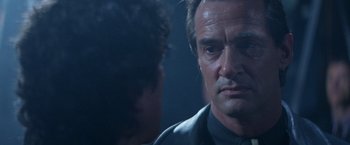 Movie still from “Mr. Nice Guy” (1997), directed by Sammo Kam-Bo Hung – A person talking to another person; Close Up shot, Over the shoulder angle