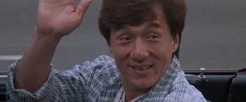 Movie still from “Mr. Nice Guy” (1997), directed by Sammo Kam-Bo Hung – A person smiling and waving; Close Up shot, Low angle