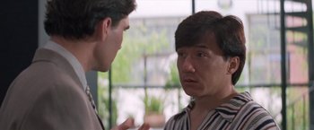 Movie still from “Mr. Nice Guy” (1997), directed by Sammo Kam-Bo Hung – Two men are having a conversation in front of a window; Close Up shot, Over the shoulder angle