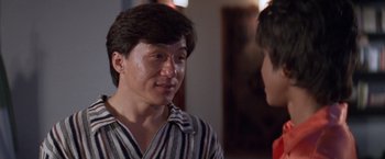 Movie still from “Mr. Nice Guy” (1997), directed by Sammo Kam-Bo Hung – A man talking to another man in front of a mirror; Close Up shot, Over the shoulder angle