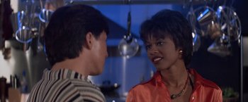 Movie still from “Mr. Nice Guy” (1997), directed by Sammo Kam-Bo Hung – A woman and a man are talking in a kitchen; Close Up shot, Over the shoulder angle
