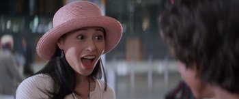 Movie still from “Mr. Nice Guy” (1997), directed by Sammo Kam-Bo Hung – A young woman wearing a pink straw hat; Close Up shot, High angle