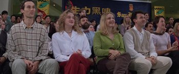 Movie still from “Mr. Nice Guy” (1997), directed by Sammo Kam-Bo Hung – Two women sitting in a crowd of people; Medium shot, Low angle