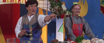 Movie still from “Mr. Nice Guy” (1997), directed by Sammo Kam-Bo Hung – A man holding a spatula in front of another man; Medium shot, Over the shoulder angle