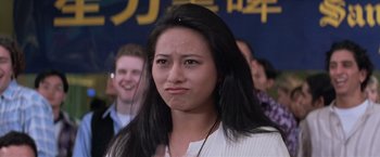 Movie still from “Mr. Nice Guy” (1997), directed by Sammo Kam-Bo Hung – A young woman with long black hair is looking at the camera; Close Up shot, Low angle