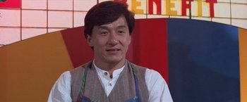 Movie still from “Mr. Nice Guy” (1997), directed by Sammo Kam-Bo Hung – A man in a white shirt and a brown vest; Close Up shot, Over the shoulder angle