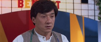 Movie still from “Mr. Nice Guy” (1997), directed by Sammo Kam-Bo Hung – A person wearing a shirt and vest; Close Up shot, Over the shoulder angle