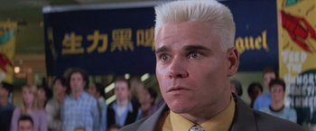 Movie still from “Mr. Nice Guy” (1997), directed by Sammo Kam-Bo Hung – A man with blonde hair and a yellow shirt; Close Up shot, Low angle