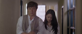 Movie still from “Mr. Nice Guy” (1997), directed by Sammo Kam-Bo Hung – A man and a woman standing next to each other; Medium shot, Over the shoulder angle