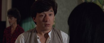 Movie still from “Mr. Nice Guy” (1997), directed by Sammo Kam-Bo Hung – A person wearing a shirt and vest; Close Up shot, Over the shoulder angle