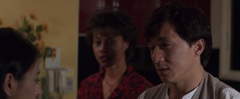 Movie still from “Mr. Nice Guy” (1997), directed by Sammo Kam-Bo Hung – A man and a woman standing next to each other in a room; Close Up shot, Over the shoulder angle