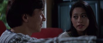 Movie still from “Mr. Nice Guy” (1997), directed by Sammo Kam-Bo Hung – A man and a woman sitting on a red couch; Close Up shot, Over the shoulder angle