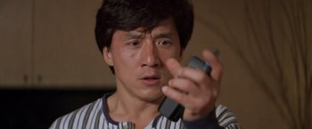 Movie still from “Mr. Nice Guy” (1997), directed by Sammo Kam-Bo Hung – A man holding a cell phone in his hand; Close Up shot, High angle