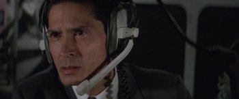 Movie still from “Mr. Nice Guy” (1997), directed by Sammo Kam-Bo Hung – A person wearing a headset; Close Up shot, High angle