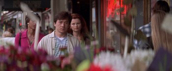 Movie still from “Mr. Nice Guy” (1997), directed by Sammo Kam-Bo Hung – A man and a woman standing next to each other; Medium shot, Over the shoulder angle