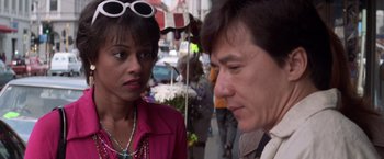 Movie still from “Mr. Nice Guy” (1997), directed by Sammo Kam-Bo Hung – A man and a woman standing next to each other on the street; Close Up shot, Over the shoulder angle