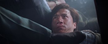 Movie still from “Mr. Nice Guy” (1997), directed by Sammo Kam-Bo Hung – A man's face as he looks upward; Close Up shot, Low angle