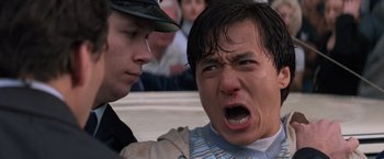 Movie still from “Mr. Nice Guy” (1997), directed by Sammo Kam-Bo Hung – A man is crying while being held by a police officer; Close Up shot, Low angle