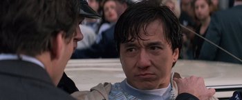 Movie still from “Mr. Nice Guy” (1997), directed by Sammo Kam-Bo Hung – A person with his face close to another person; Close Up shot, Over the shoulder angle