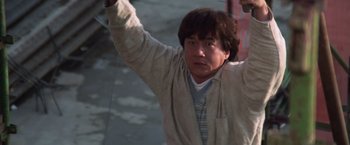 Movie still from “Mr. Nice Guy” (1997), directed by Sammo Kam-Bo Hung – A man holding his arms up in the air; Medium shot, Low angle