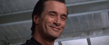 Movie still from “Mr. Nice Guy” (1997), directed by Sammo Kam-Bo Hung – A person smiling with his eyes closed; Close Up shot, Low angle