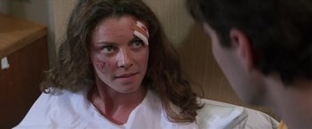 Movie still from “Mr. Nice Guy” (1997), directed by Sammo Kam-Bo Hung – A woman with a bandage on her head; Close Up shot, Over the shoulder angle