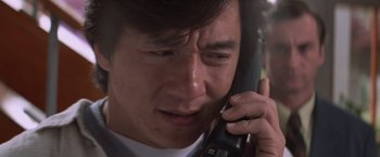 Movie still from “Mr. Nice Guy” (1997), directed by Sammo Kam-Bo Hung – A person talking on a cell phone; Close Up shot, Low angle