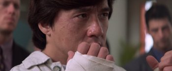 Movie still from “Mr. Nice Guy” (1997), directed by Sammo Kam-Bo Hung – A person holding a napkin to his face; Close Up shot, Low angle