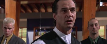 Movie still from “Mr. Nice Guy” (1997), directed by Sammo Kam-Bo Hung – A person wearing a suit and tie; Close Up shot, Low angle