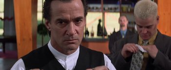 Movie still from “Mr. Nice Guy” (1997), directed by Sammo Kam-Bo Hung – A person tying a tie; Close Up shot, Over the shoulder angle