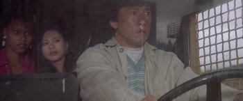 Movie still from “Mr. Nice Guy” (1997), directed by Sammo Kam-Bo Hung – A person sitting in a car; Close Up shot, Low angle