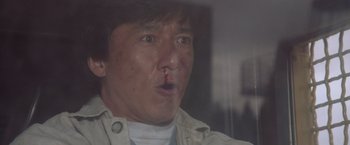 Movie still from “Mr. Nice Guy” (1997), directed by Sammo Kam-Bo Hung – A person with a knife in his mouth; Close Up shot, Low angle