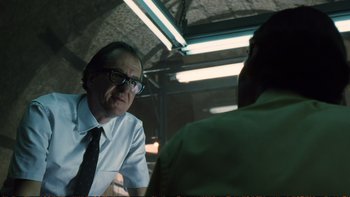 Movie still from “Munich” (2005), directed by Steven Spielberg – A man wearing glasses talking to another man; Close Up shot, Low angle
