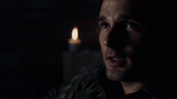 Movie still from “Munich” (2005), directed by Steven Spielberg – A person with a candle in the background; Close Up shot, Over the shoulder angle