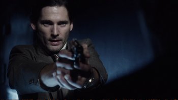 Movie still from “Munich” (2005), directed by Steven Spielberg – A man in a suit and tie holding a gun in his hand; Close Up shot, Low angle