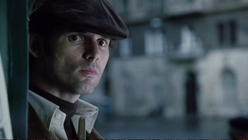 Movie still from “Munich” (2005), directed by Steven Spielberg – A person wearing a hat; Close Up shot, Low angle