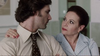 Movie still from “Munich” (2005), directed by Steven Spielberg – A man and a woman standing next to each other; Close Up shot, Over the shoulder angle