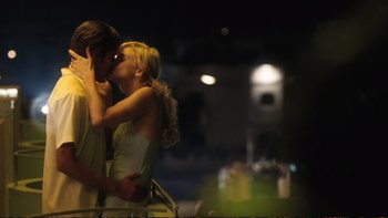 Movie still from “Munich” (2005), directed by Steven Spielberg – A man and a woman kissing in the dark; Medium shot, Over the shoulder angle