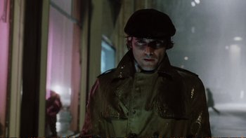 Movie still from “Munich” (2005), directed by Steven Spielberg – A man in a hat and glasses wearing a jacket; Close Up shot, Low angle
