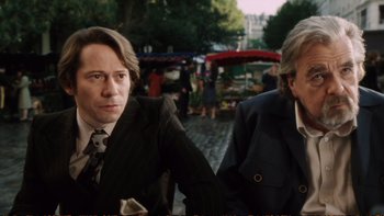 Movie still from “Munich” (2005), directed by Steven Spielberg – A man and a woman in business suits; Medium shot, Low angle