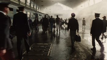 Movie still from “Munich” (2005), directed by Steven Spielberg – A group of people are walking in a train station; Extreme Wide shot, Low angle