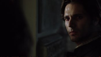 Movie still from “Munich” (2005), directed by Steven Spielberg – A person wearing a suit and tie; Close Up shot, Over the shoulder angle